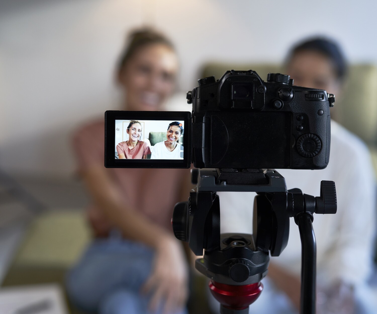 Selective focus on two female vloggers recording a movie
